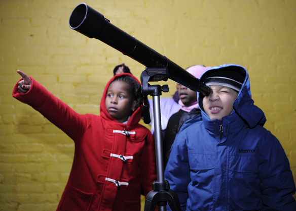 Kids looking through telescope.